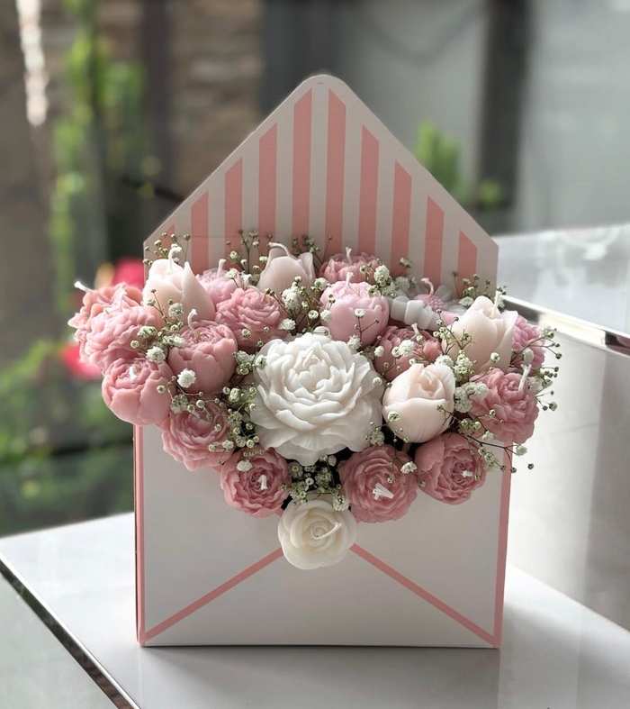 An envelope box packed with hand-poured rose and peony candles