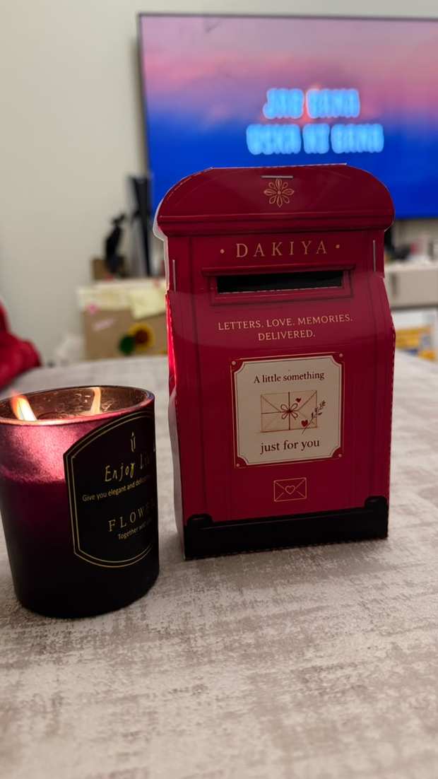 The little red Dakiya postbox on a desk